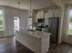 Modern kitchen featuring a center island, stainless steel appliances, and white cabinets at 12 Lavender Ln, Clayton, NC 27520