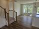 Open-concept living space with hardwood floors and staircase access, showcasing a bright interior at 12 Lavender Ln, Clayton, NC 27520