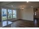 Bright living room with large windows, hardwood floors, and modern light fixture at 12 Lavender Ln, Clayton, NC 27520