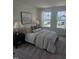 Comfortable main bedroom with two large windows, a bed and two end tables with lamps at 12 Lavender Ln, Clayton, NC 27520