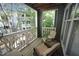 Charming balcony offering an outdoor seating area with views of mature trees and surrounding properties at 1211 Westview Ln # 201, Raleigh, NC 27605