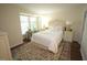 Cozy bedroom includes wooden floors, window, rug, and neutral paint color scheme at 1211 Westview Ln # 201, Raleigh, NC 27605