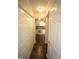 Hallway leading to kitchen with hardwood floors and multiple storage closets at 1211 Westview Ln # 201, Raleigh, NC 27605