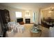Traditional living room with fireplace and adjacent dining room in neutral paint color scheme at 1211 Westview Ln # 201, Raleigh, NC 27605