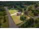 Aerial view of home with property lines showcasing lawn, trees and outbuildings at 123 Sanders Road Rd, Benson, NC 27504