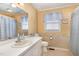 The bathroom includes patterned wallpaper, a vanity, a mirror, and a shower with curtain at 123 Sanders Road Rd, Benson, NC 27504