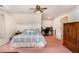 Large bedroom featuring a patterned wallpaper, pink carpet, office desk, and closet at 123 Sanders Road Rd, Benson, NC 27504