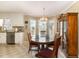 Bright dining area with large windows, chandelier, and a hutch cabinet at 123 Sanders Road Rd, Benson, NC 27504