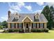 Charming Cape Cod-style home with dormers, black shutters, brick chimney, and a lush green lawn at 123 Sanders Road Rd, Benson, NC 27504