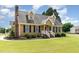 Charming Cape Cod-style home with dormers, black shutters, brick chimney, and a lush green lawn at 123 Sanders Road Rd, Benson, NC 27504