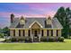 Charming Cape Cod-style home with dormers, black shutters, brick chimney, and a lush green lawn at 123 Sanders Road Rd, Benson, NC 27504