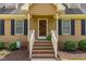 Inviting front porch with brick steps, white railings, and a charming entrance at 123 Sanders Road Rd, Benson, NC 27504