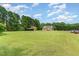 Wide view of the home and property with large grassy area and wooded surround at 123 Sanders Road Rd, Benson, NC 27504