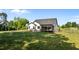 Spacious backyard with lush green lawn, screened porch and a black metal fence at 15 Willow Bend Dr, Youngsville, NC 27596