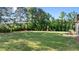 Expansive backyard featuring a playset, seating, and ample lawn space for recreation and relaxation at 15 Willow Bend Dr, Youngsville, NC 27596