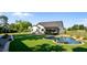 Expansive backyard featuring a sparkling pool, lush lawn, and a charming screened-in porch, perfect for outdoor living at 15 Willow Bend Dr, Youngsville, NC 27596