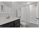 Clean bathroom featuring a vanity with a dark wood cabinet, a toilet and a shower/tub combo at 15 Willow Bend Dr, Youngsville, NC 27596