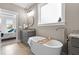 Relaxing bathroom featuring a soaking tub, granite countertop vanity, and tile flooring near a bedroom at 15 Willow Bend Dr, Youngsville, NC 27596
