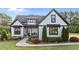 Charming home exterior with black framed windows, manicured landscaping and welcoming front porch at 15 Willow Bend Dr, Youngsville, NC 27596