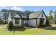 Beautiful home with lush landscaping and a welcoming entryway with chairs on the covered porch at 15 Willow Bend Dr, Youngsville, NC 27596