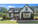 Charming home exterior with black framed windows, manicured landscaping and welcoming front porch at 15 Willow Bend Dr, Youngsville, NC 27596