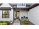 Inviting front porch with rocking chairs and brick-lined steps, framed by dark trim and white siding at 15 Willow Bend Dr, Youngsville, NC 27596