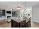 Kitchen island featuring gray veined granite countertops and a stainless steel farm sink at 15 Willow Bend Dr, Youngsville, NC 27596