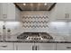 Gourmet kitchen featuring a granite countertop, stainless steel gas range, and tile backsplash at 15 Willow Bend Dr, Youngsville, NC 27596