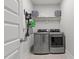 Organized laundry room featuring modern washer and dryer, shelving, and ample storage at 15 Willow Bend Dr, Youngsville, NC 27596