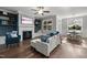 Spacious living room with a fireplace, built-in shelving, large windows, and comfortable seating at 15 Willow Bend Dr, Youngsville, NC 27596