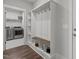 Mud room area featuring built-in storage, hooks, a bench, and convenient access to the laundry room at 15 Willow Bend Dr, Youngsville, NC 27596