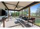 Relaxing screened porch with comfortable seating, a hanging chair and a mounted TV at 15 Willow Bend Dr, Youngsville, NC 27596