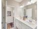 Bathroom with dual sink vanity, modern fixtures, large mirror, and sleek wood style floor at 1602 Red Roses Way, Durham, NC 27703