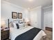 Cozy bedroom featuring a comfortable bed with decorative pillows and framed artwork at 1602 Red Roses Way, Durham, NC 27703
