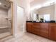 Bathroom boasts a double vanity with granite countertops, and a tiled glass shower at 1605 Park Dr, Raleigh, NC 27605
