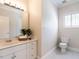 Bright bathroom features a single sink vanity with white cabinets and a framed mirror at 1605 Park Dr, Raleigh, NC 27605