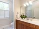 Bathroom with a vanity, a sink, a white countertop, and a large window at 1605 Park Dr, Raleigh, NC 27605