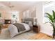 Bright bedroom features a decorative fireplace, built-in shelving, and hardwood floors at 1605 Park Dr, Raleigh, NC 27605