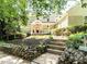 Charming two-story home with a welcoming front porch and stone-lined flower beds leading to the entrance at 1605 Park Dr, Raleigh, NC 27605