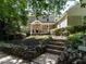 Inviting two-story home with a covered porch, stone-lined garden and mature trees at 1605 Park Dr, Raleigh, NC 27605