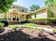 Inviting two-story home featuring a covered porch and meticulously landscaped front yard with a winding walkway at 1605 Park Dr, Raleigh, NC 27605