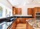 Kitchen featuring wooden cabinets, granite counters, stainless appliances, and garden view at 1605 Park Dr, Raleigh, NC 27605