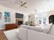 Bright living room with a stone fireplace, ceiling fans, and access to the outdoors at 1605 Park Dr, Raleigh, NC 27605