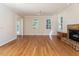 Open living room with hardwood floors, a brick fireplace, recessed lighting and large windows with natural light at 1605 Park Dr, Raleigh, NC 27605
