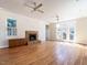 Bright, open living room with hardwood floors, a stone fireplace, recessed lighting, ceiling fans, and natural light at 1605 Park Dr, Raleigh, NC 27605