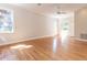 Spacious living room with gleaming hardwood floors, natural light, and a ceiling fan at 1605 Park Dr, Raleigh, NC 27605