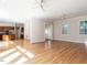 Open-concept living area with hardwood floors flowing into the kitchen with wooden cabinets and stainless appliances at 1605 Park Dr, Raleigh, NC 27605