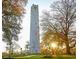 Memorial Belltower framed by autumn trees with sunlight peeking through the branches at 1605 Park Dr, Raleigh, NC 27605