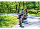Gathering biking together on a paved path through a lush green park, enjoying outdoor activities at 1605 Park Dr, Raleigh, NC 27605
