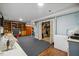 Partially finished basement with bi-fold doors, open shelving, freezer, and carpet at 1924 Strebor St, Durham, NC 27705